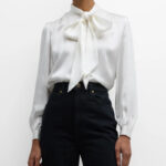 Are black pants with a white bow blouse professional?