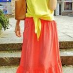 Your red maxi skirt with the dipped hem sounds très chic. Bold colors are very trendy and would be fabulous with your red skirt.